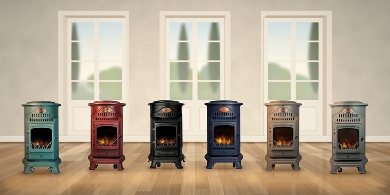 Les six poêles à gaz Provence alignés sur un parquet en chêne devant de hautes portes-fenêtres : vert, rouge, noir mat, bleu marine, marron miel et gris